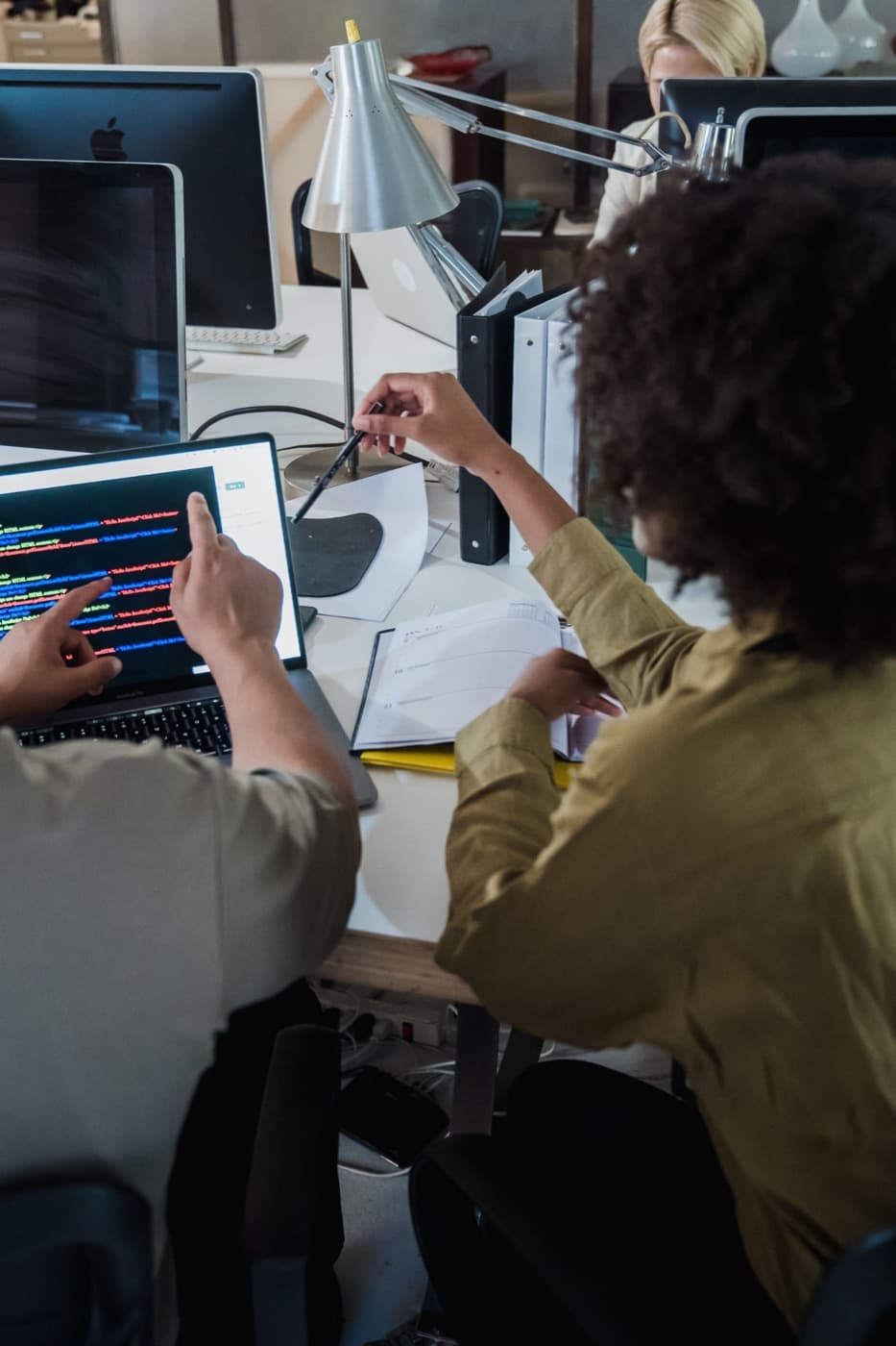 Developers reviewing code together on a laptop