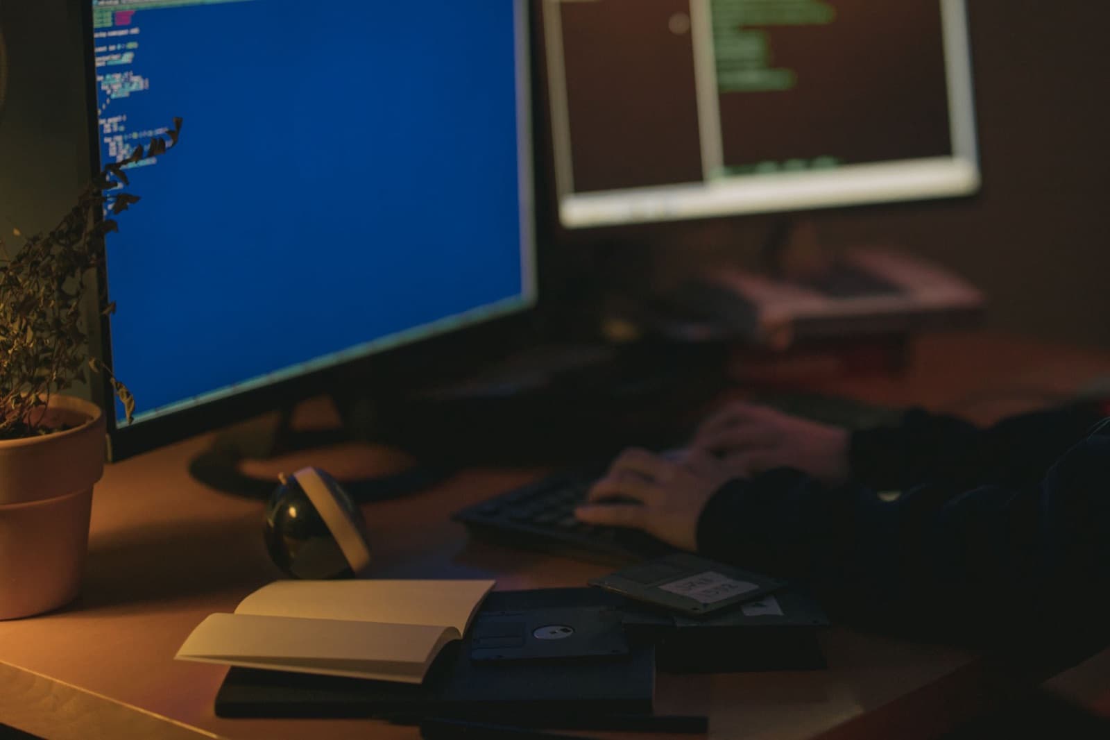 Developer writing code at a dual-monitor workstation